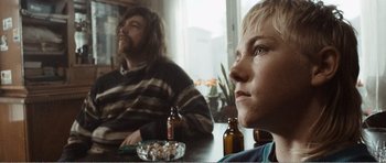 Movie still from “The Misfortunates” (2009), directed by Felix van Groeningen – Two people sitting at a table with a bowl of food; Close Up shot, Low angle