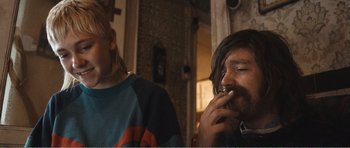 Movie still from “The Misfortunates” (2009), directed by Felix van Groeningen – Two people sitting in front of each other eating food; Medium shot, Over the shoulder angle