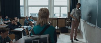 Movie still from “The Misfortunates” (2009), directed by Felix van Groeningen – A group of people sitting in front of a window; Medium shot, Over the shoulder angle