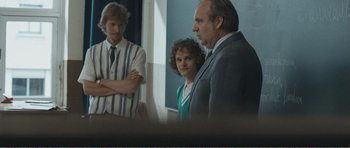 Movie still from “The Misfortunates” (2009), directed by Felix van Groeningen – A man and a woman standing next to each other in a room; Medium shot, Over the shoulder angle