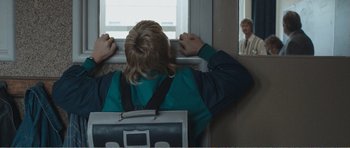 Movie still from “The Misfortunates” (2009), directed by Felix van Groeningen – A woman is sitting on a bus looking out the window; Medium shot, Over the shoulder angle