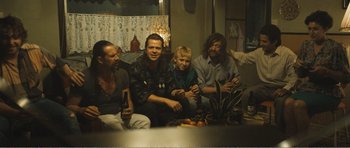 Movie still from “The Misfortunates” (2009), directed by Felix van Groeningen – A group of people sitting around a table; Medium shot, High angle