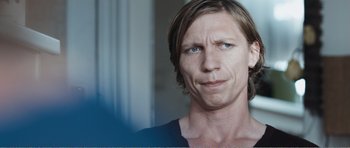 Movie still from “The Misfortunates” (2009), directed by Felix van Groeningen – A person with long brown hair; Close Up shot, Over the shoulder angle