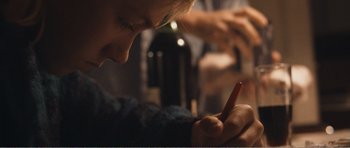 Movie still from “The Misfortunates” (2009), directed by Felix van Groeningen – A person writing on a piece of paper; Close Up shot, Over the shoulder angle