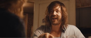 Movie still from “The Misfortunates” (2009), directed by Felix van Groeningen – A person with long brown hair; Close Up shot, Over the shoulder angle