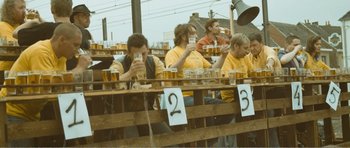 Movie still from “The Misfortunates” (2009), directed by Felix van Groeningen – A group of men sitting at a table drinking beer; Wide shot, High angle