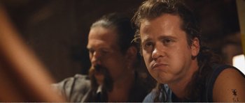 Movie still from “The Misfortunates” (2009), directed by Felix van Groeningen – A man with long hair and a beard and a man with long hair; Close Up shot, Over the shoulder angle