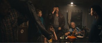 Movie still from “The Misfortunates” (2009), directed by Felix van Groeningen – A group of people sitting around a table; Medium shot, Over the shoulder angle