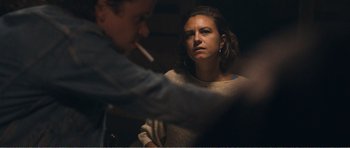 Movie still from “The Misfortunates” (2009), directed by Felix van Groeningen – A man and a woman sitting in front of each other; Medium shot, Over the shoulder angle