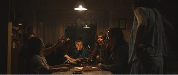 Movie still from “The Misfortunates” (2009), directed by Felix van Groeningen – A group of people sitting around a table; Wide shot, High angle