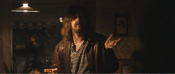 Movie still from “The Misfortunates” (2009), directed by Felix van Groeningen – A man with long hair wearing a leather jacket; Medium shot, Low angle