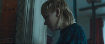 Movie still from “The Misfortunates” (2009), directed by Felix van Groeningen – A boy with blonde hair looking out of a window; Close Up shot, Over the shoulder angle