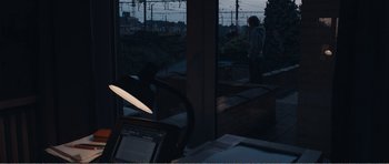 Movie still from “The Misfortunates” (2009), directed by Felix van Groeningen – A person standing in front of a window at night; Wide shot, Over the shoulder angle