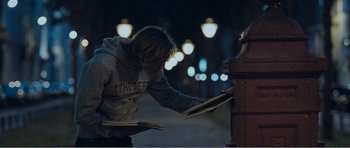 Movie still from “The Misfortunates” (2009), directed by Felix van Groeningen – A man is holding a bunch of pizza boxes; Medium shot, Low angle