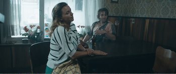 Movie still from “The Misfortunates” (2009), directed by Felix van Groeningen – Two women sitting at a table drinking beer; Medium shot, Over the shoulder angle