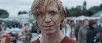 Movie still from “The Misfortunates” (2009), directed by Felix van Groeningen – A person with long blonde hair; Close Up shot, Low angle