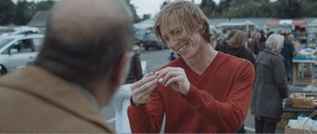 Movie still from “The Misfortunates” (2009), directed by Felix van Groeningen – A man holding a cigarette in one hand and a cigarette in the other hand; Close Up shot, Over the shoulder angle