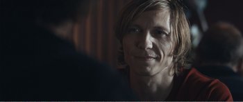 Movie still from “The Misfortunates” (2009), directed by Felix van Groeningen – A person with long blonde hair; Close Up shot, Over the shoulder angle