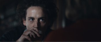 Movie still from “The Misfortunates” (2009), directed by Felix van Groeningen – A person sitting in front of a window; Close Up shot, Over the shoulder angle