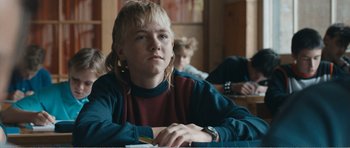 Movie still from “The Misfortunates” (2009), directed by Felix van Groeningen – A young person sitting at a table in front of a laptop; Close Up shot, Over the shoulder angle