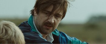 Movie still from “The Misfortunates” (2009), directed by Felix van Groeningen – A person wearing a jacket; Close Up shot, Over the shoulder angle