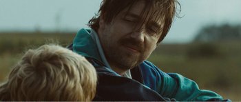 Movie still from “The Misfortunates” (2009), directed by Felix van Groeningen – A person with a dog; Close Up shot, Over the shoulder angle