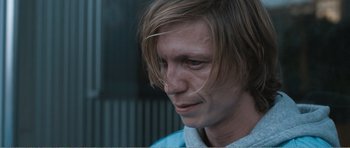 Movie still from “The Misfortunates” (2009), directed by Felix van Groeningen – A person with long blonde hair; Close Up shot, High angle