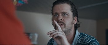 Movie still from “The Misfortunates” (2009), directed by Felix van Groeningen – A person with his hand to his face; Close Up shot, Over the shoulder angle