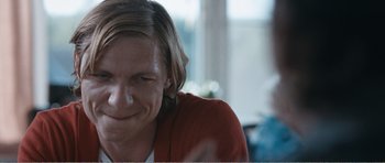 Movie still from “The Misfortunates” (2009), directed by Felix van Groeningen – A person with long blonde hair; Close Up shot, Over the shoulder angle