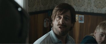 Movie still from “The Misfortunates” (2009), directed by Felix van Groeningen – A person with a beard; Close Up shot, Over the shoulder angle