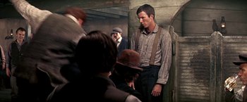 Movie still from “The Molly Maguires” (1970), directed by Martin Ritt – A group of people standing in a room; Medium shot, Over the shoulder angle