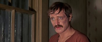 Movie still from “The Molly Maguires” (1970), directed by Martin Ritt – A person with a beard and a mustache; Close Up shot, Over the shoulder angle