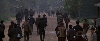 Movie still from “The Molly Maguires” (1970), directed by Martin Ritt – A group of men walking down a dirt road; Wide shot, High angle
