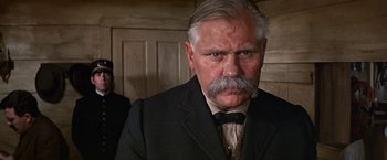 Movie still from “The Molly Maguires” (1970), directed by Martin Ritt – An older man wearing a suit and a bow tie; Close Up shot, Low angle