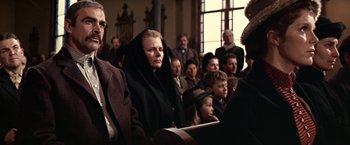 Movie still from “The Molly Maguires” (1970), directed by Martin Ritt – A group of people sitting in a room; Medium shot, Low angle