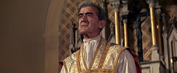 Movie still from “The Molly Maguires” (1970), directed by Martin Ritt – An older man wearing a priest's vestment; Close Up shot, Low angle