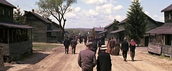 Movie still from “The Molly Maguires” (1970), directed by Martin Ritt – A group of people walking down a dirt road; Extreme Wide shot, High angle