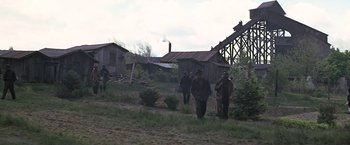 Movie still from “The Molly Maguires” (1970), directed by Martin Ritt – A group of men walking across a lush green field; Extreme Wide shot, Low angle