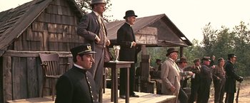 Movie still from “The Molly Maguires” (1970), directed by Martin Ritt – A group of men standing next to each other on a platform; Wide shot, Low angle