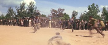 Movie still from “The Molly Maguires” (1970), directed by Martin Ritt – A group of men running and playing baseball in the dirt; Wide shot, High angle