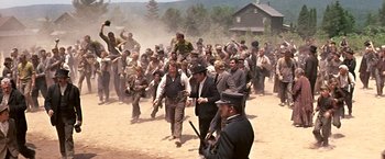 Movie still from “The Molly Maguires” (1970), directed by Martin Ritt – A group of men are gathered together in the dirt; Wide shot, High angle
