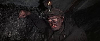 Movie still from “The Molly Maguires” (1970), directed by Martin Ritt – A man with a hat on and a candle in his head; Close Up shot, High angle