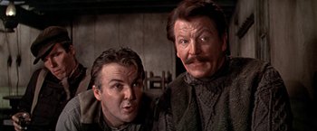 Movie still from “The Molly Maguires” (1970), directed by Martin Ritt – Two men standing next to each other in front of a wall; Close Up shot, Low angle