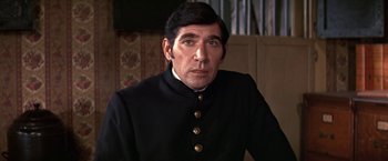 Movie still from “The Molly Maguires” (1970), directed by Martin Ritt – A person wearing a uniform; Close Up shot, Over the shoulder angle