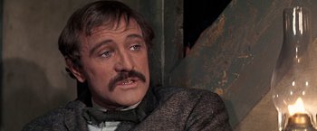 Movie still from “The Molly Maguires” (1970), directed by Martin Ritt – A person wearing a suit and tie; Close Up shot, Over the shoulder angle