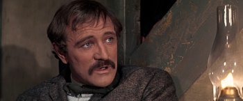 Movie still from “The Molly Maguires” (1970), directed by Martin Ritt – A person wearing a suit and tie; Close Up shot, Over the shoulder angle