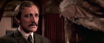 Movie still from “The Molly Maguires” (1970), directed by Martin Ritt – A man in a suit and tie next to an old man; Close Up shot, Over the shoulder angle