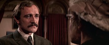 Movie still from “The Molly Maguires” (1970), directed by Martin Ritt – A man in a suit and tie looking at another man in a suit and tie; Close Up shot, Over the shoulder angle