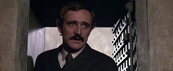 Movie still from “The Molly Maguires” (1970), directed by Martin Ritt – A person wearing a suit and tie; Close Up shot, Over the shoulder angle