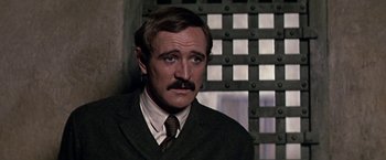 Movie still from “The Molly Maguires” (1970), directed by Martin Ritt – A person wearing a suit and a tie; Close Up shot, Over the shoulder angle